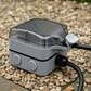 Stella Charge EV weatherproof  extension lead 3-pin socket outdoor on a concrete surface with water droplets 